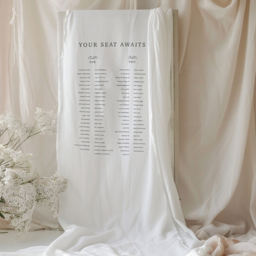 fabric seating chart sign for a wedding event, white linen fabric with black text that says "find your seat" and then the two tables with the various guest names inm columns